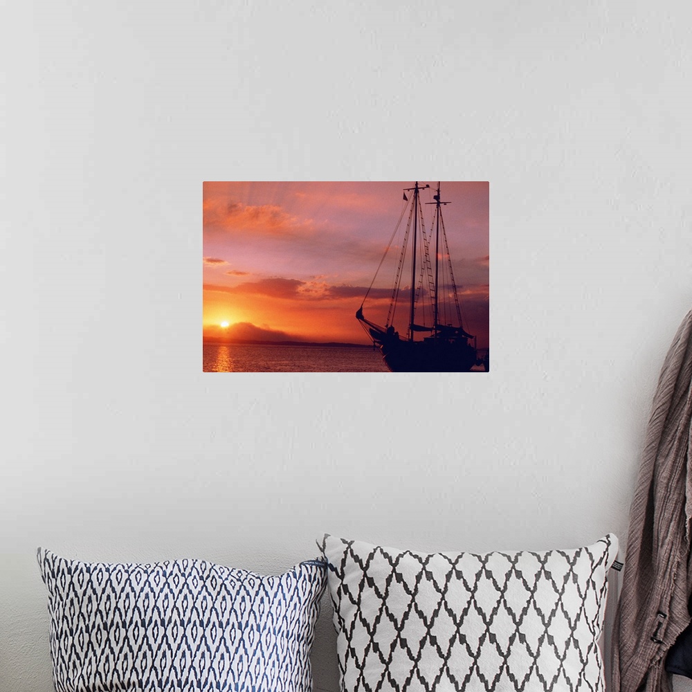 A bohemian room featuring boat at sunset