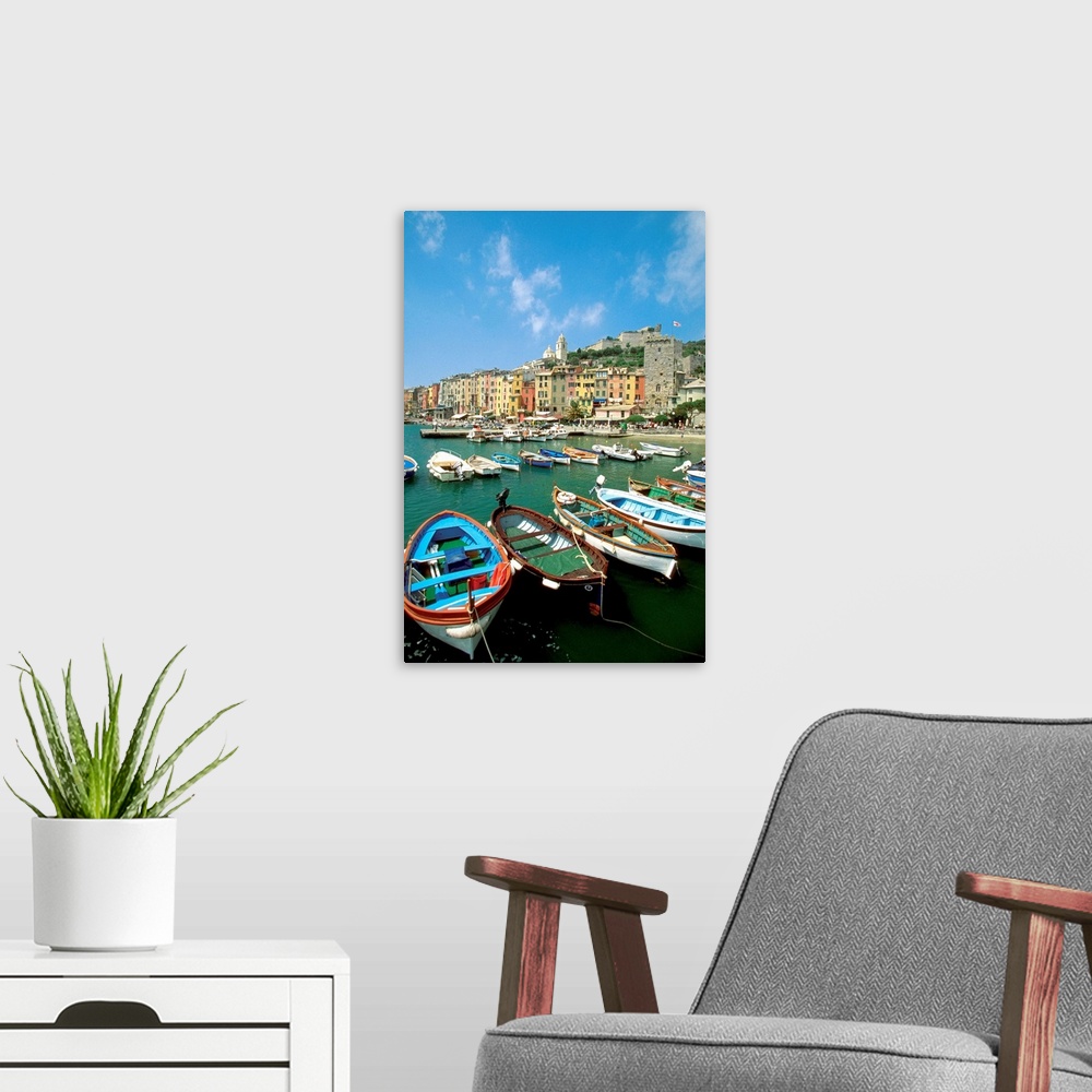 A modern room featuring Big photograph includes a wide assortment of vibrantly colored water vessels sitting docked on th...