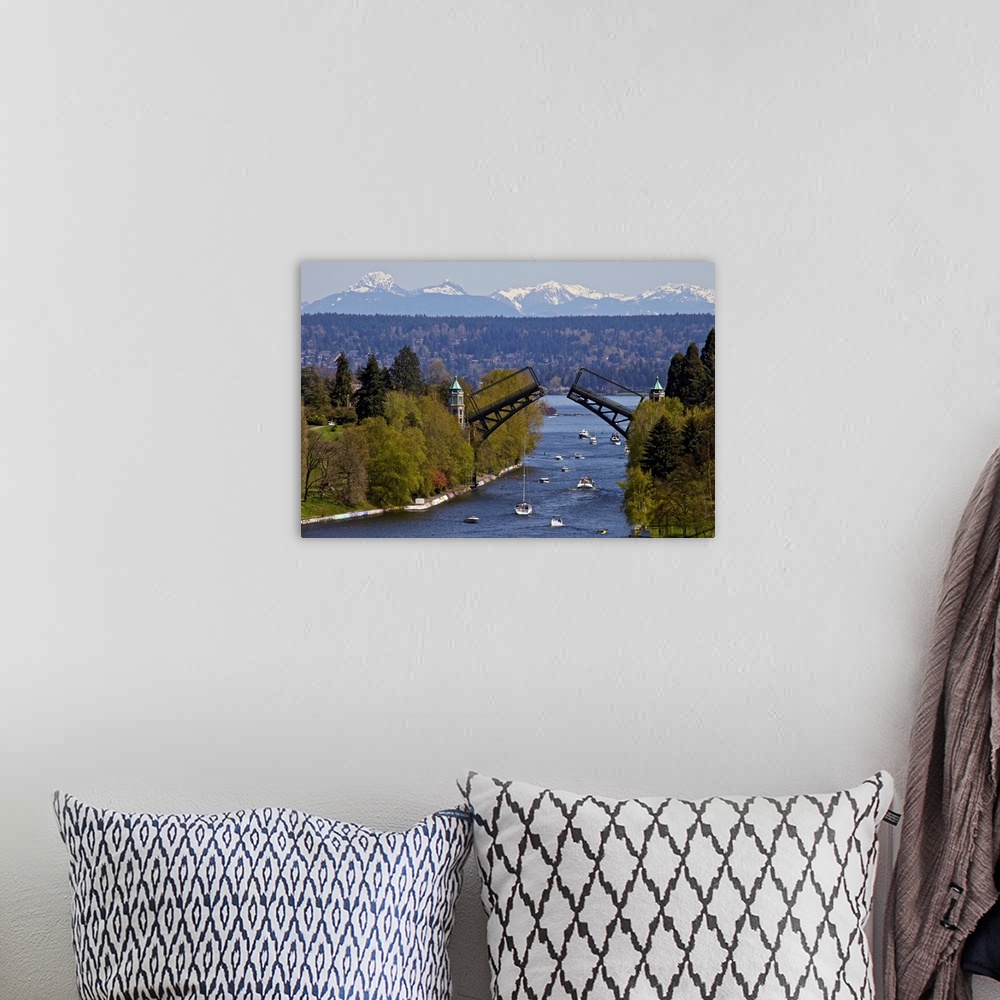 A bohemian room featuring Landscape photograph on a large wall hanging of Montlake drawbridge, raised as boats pass under i...