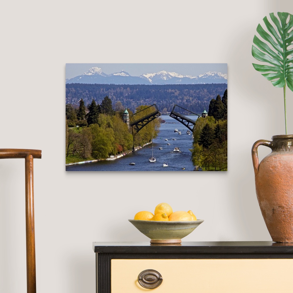 A traditional room featuring Landscape photograph on a large wall hanging of Montlake drawbridge, raised as boats pass under i...