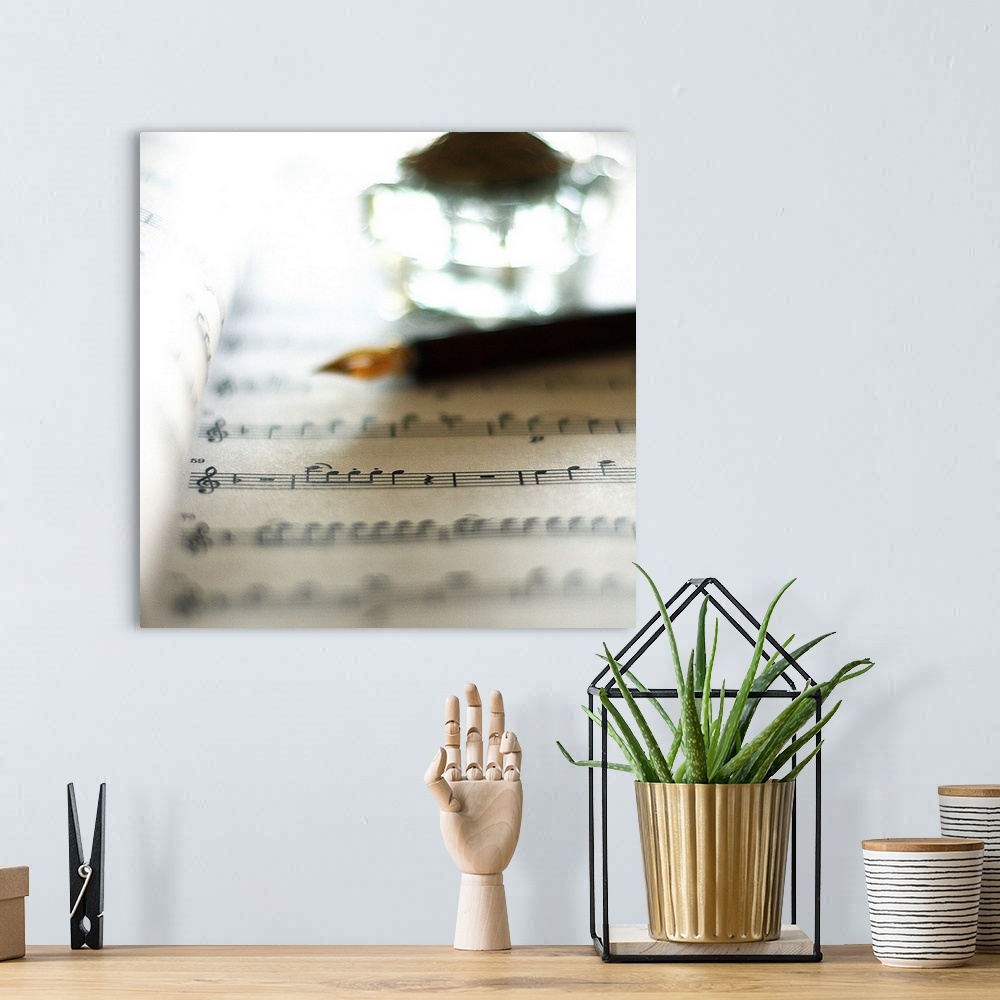 A bohemian room featuring Bokeh with sheet music, fountain pen and inkwell.