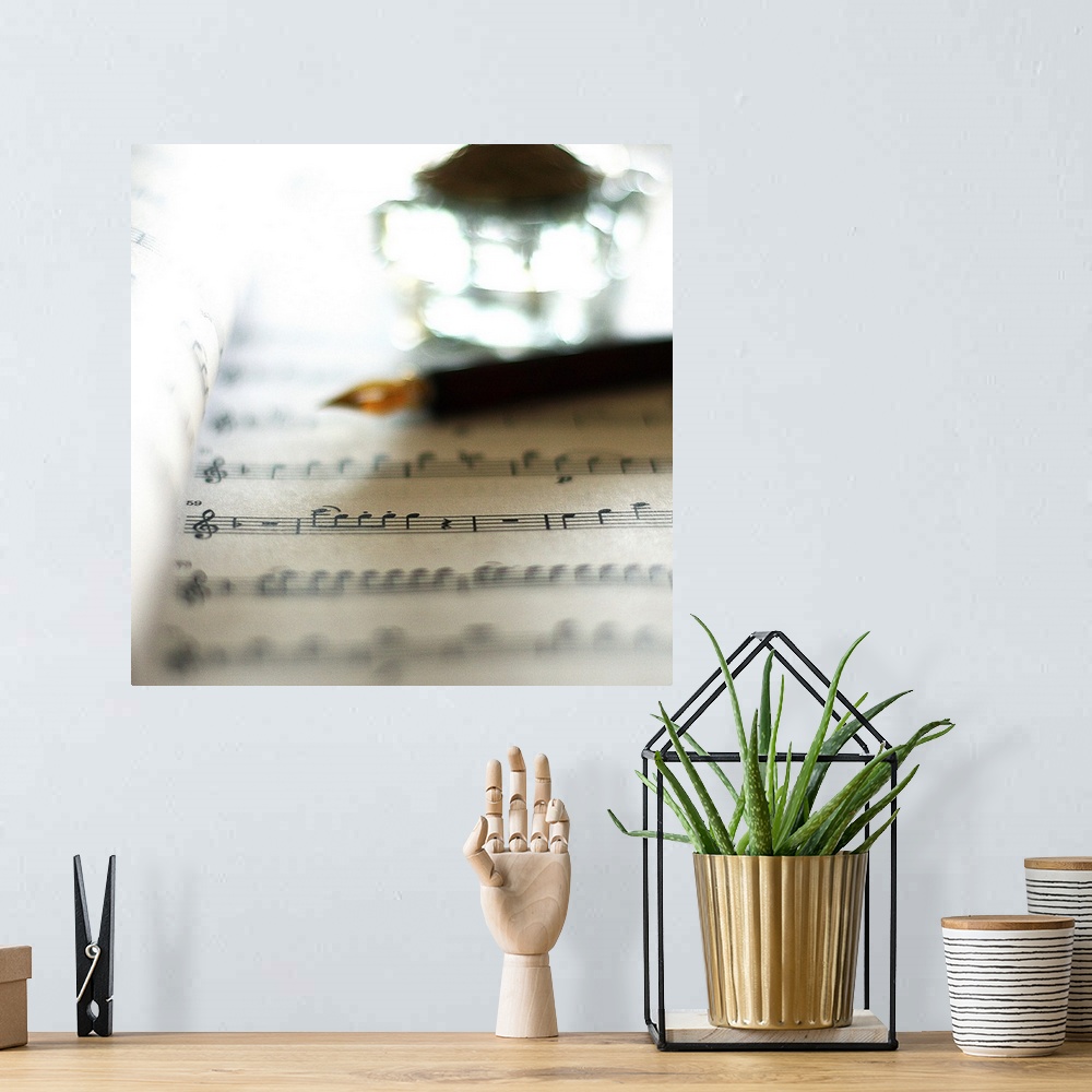 A bohemian room featuring Bokeh with sheet music, fountain pen and inkwell.