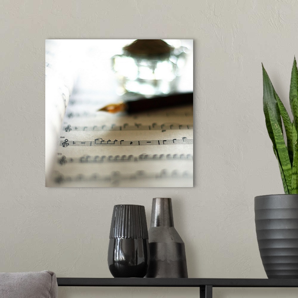 A modern room featuring Bokeh with sheet music, fountain pen and inkwell.