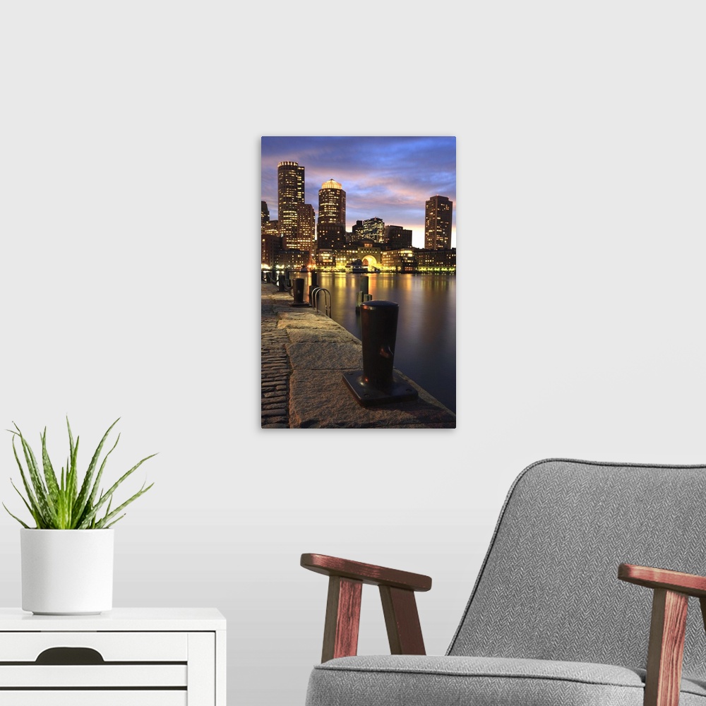 A modern room featuring Dramatic sunset over Boston Harbor and skyline.Boston is one of the oldest cities in the United S...