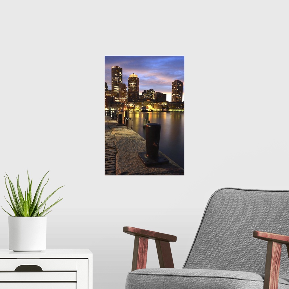 A modern room featuring Dramatic sunset over Boston Harbor and skyline.Boston is one of the oldest cities in the United S...