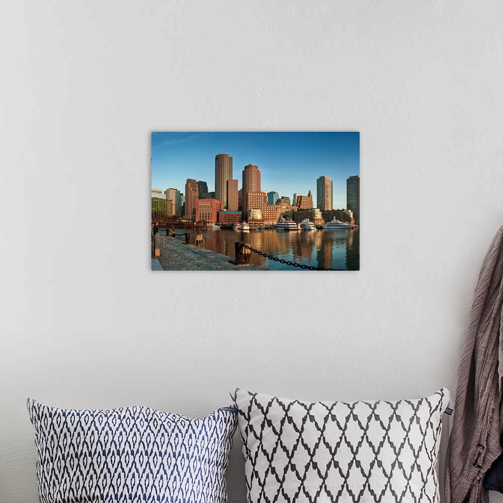 A bohemian room featuring This wall art is a horizontal photograph taken from a harbor dock that shows several skyscrapers ...