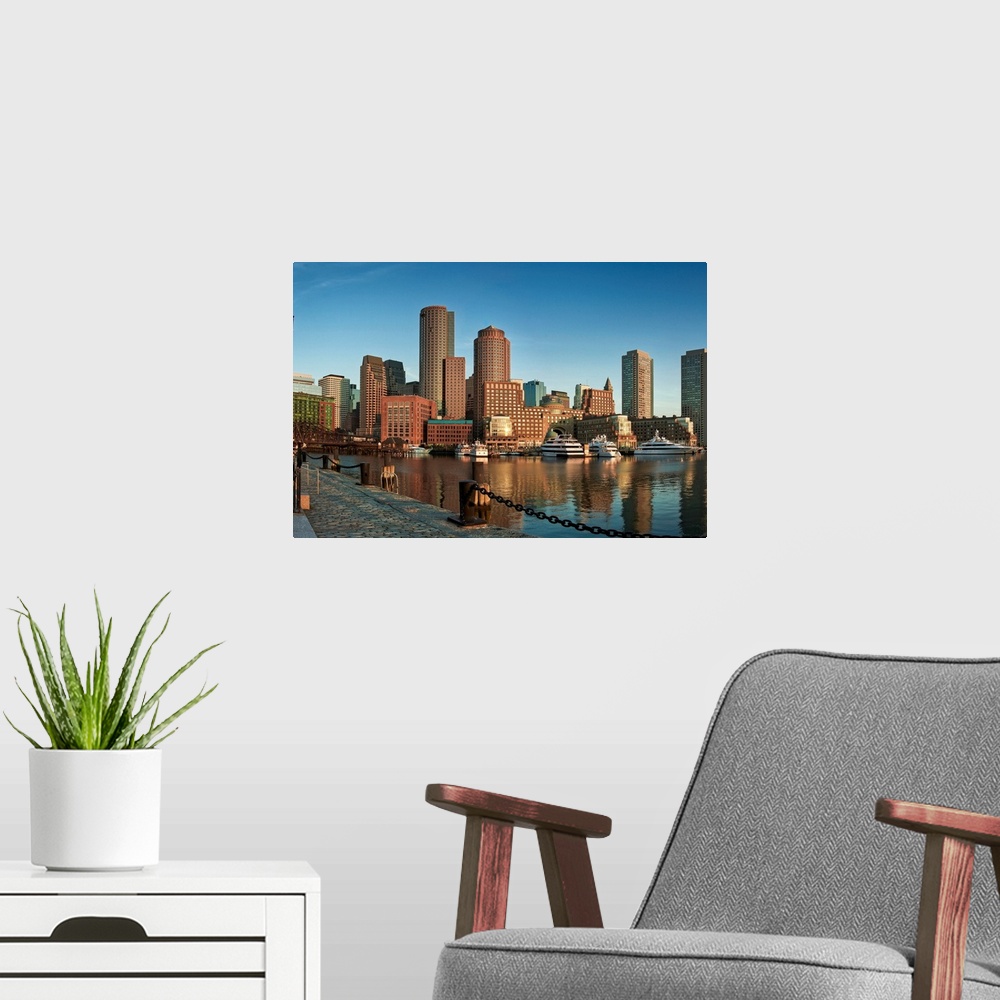 A modern room featuring This wall art is a horizontal photograph taken from a harbor dock that shows several skyscrapers ...