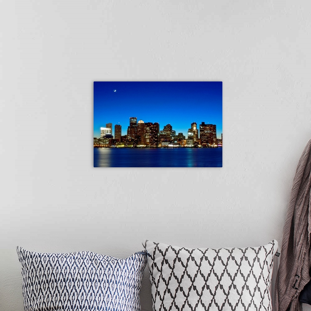 A bohemian room featuring This big photograph is of the Boston skyline under a night sky and crescent moon. Buildings are l...