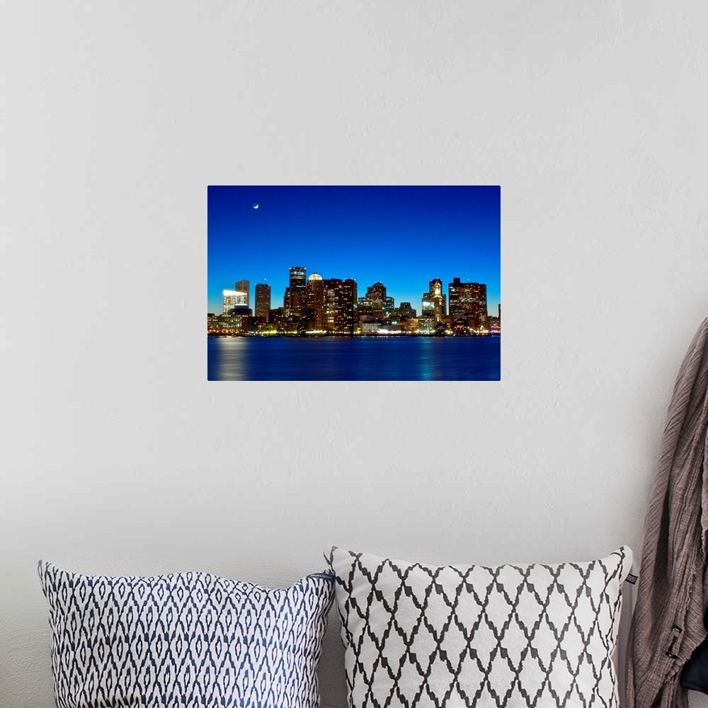 A bohemian room featuring This big photograph is of the Boston skyline under a night sky and crescent moon. Buildings are l...