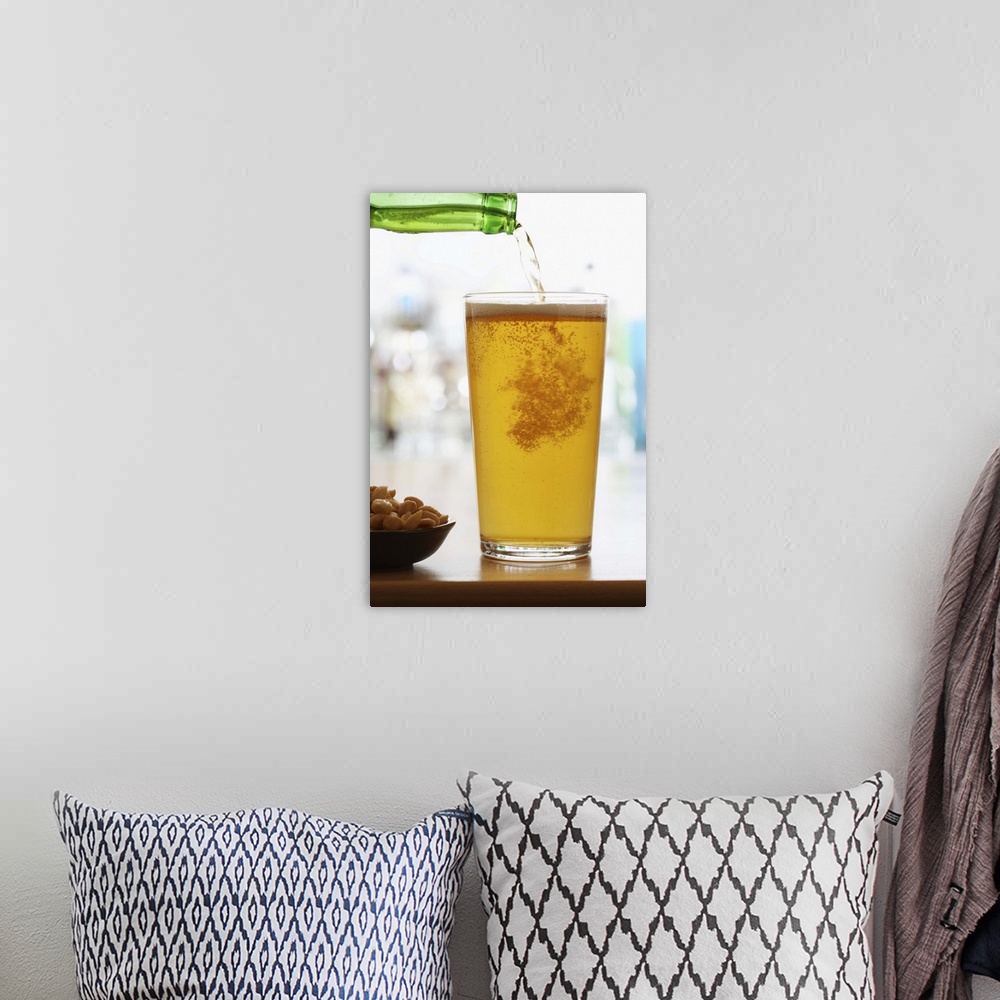 A bohemian room featuring Bottle of beer pouring into pint glass