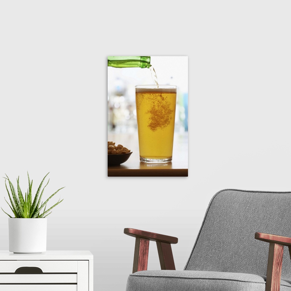A modern room featuring Bottle of beer pouring into pint glass