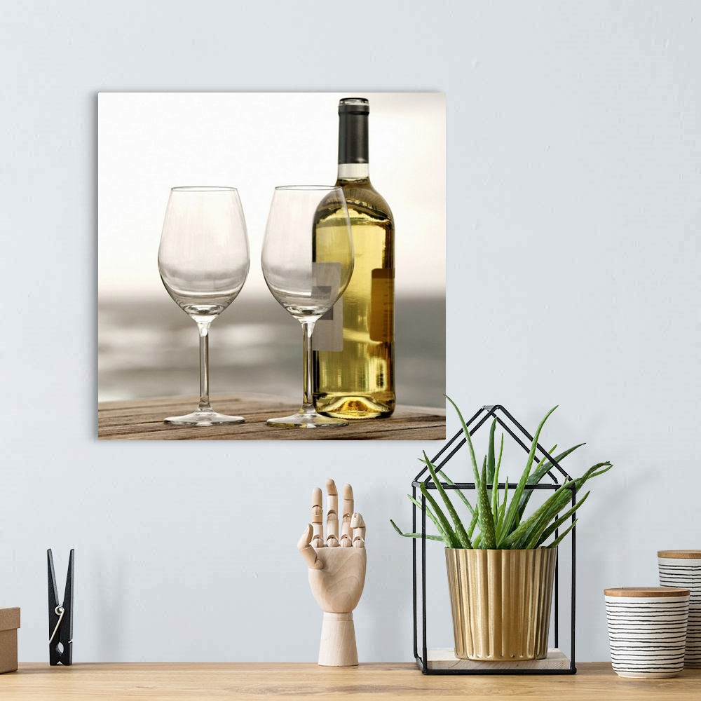 A bohemian room featuring Square photograph on a large canvas of two empty wine glasses sitting on a wooden table, along wi...