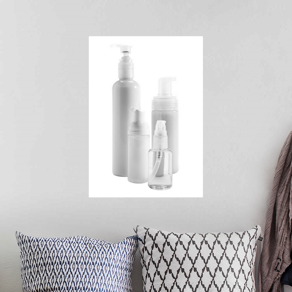 A bohemian room featuring Bottles of skin care products on white background