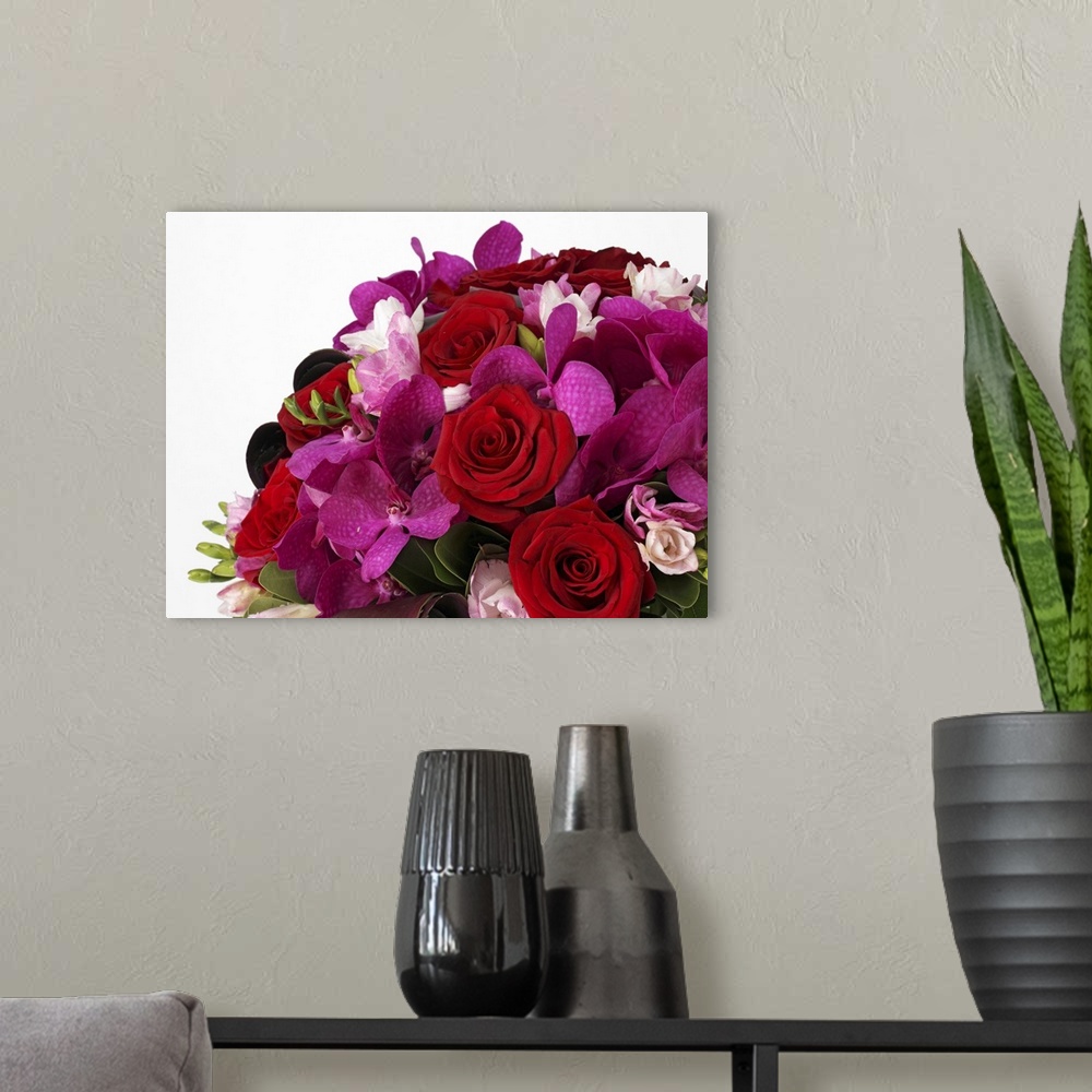 A modern room featuring Bouquet of red roses, pink freesias, purple vanda orchids