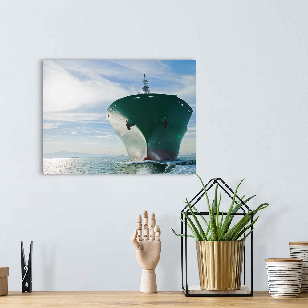 A bohemian room featuring Bow view of cargo ship sailing on ocean