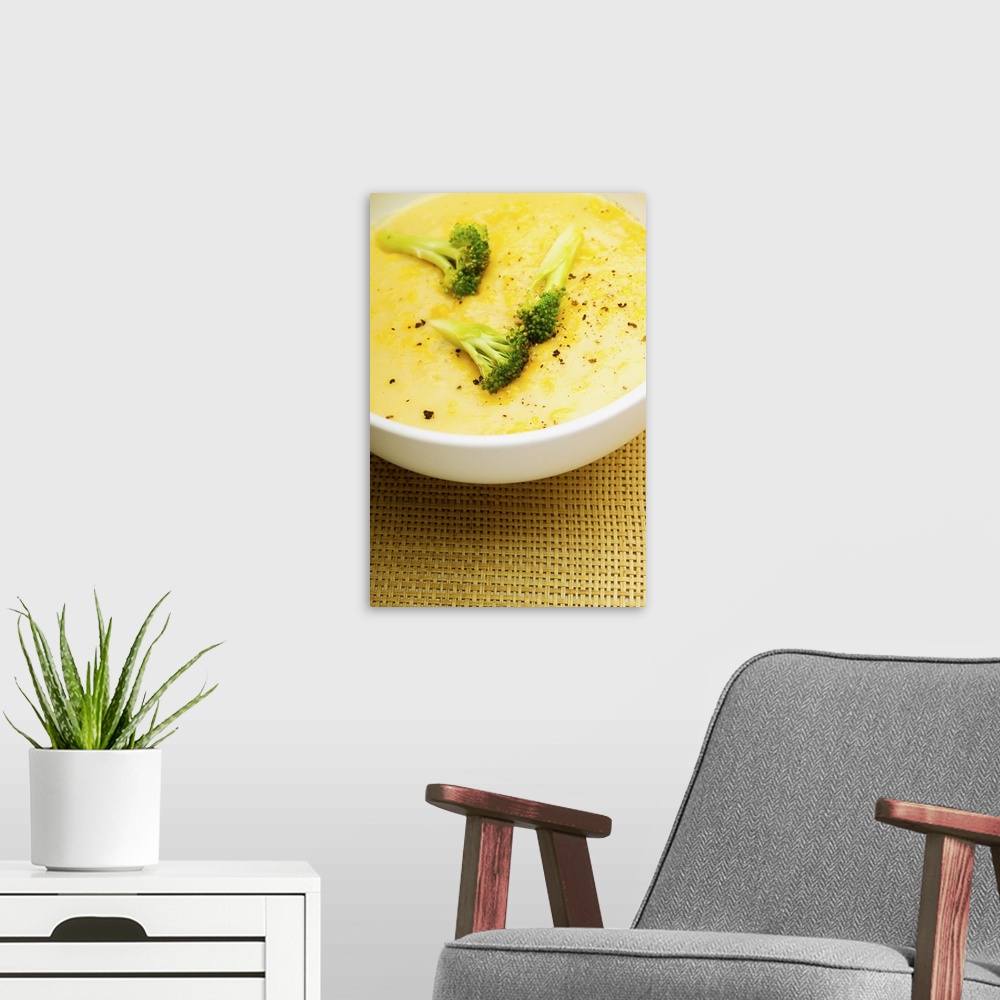 A modern room featuring Bowl of broccoli soup, close-up
