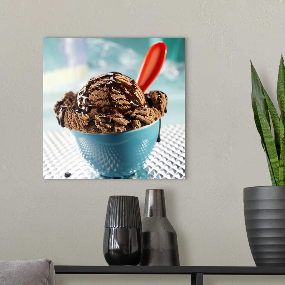 A modern room featuring Bowl of chocolate ice cream with chocolate sauce