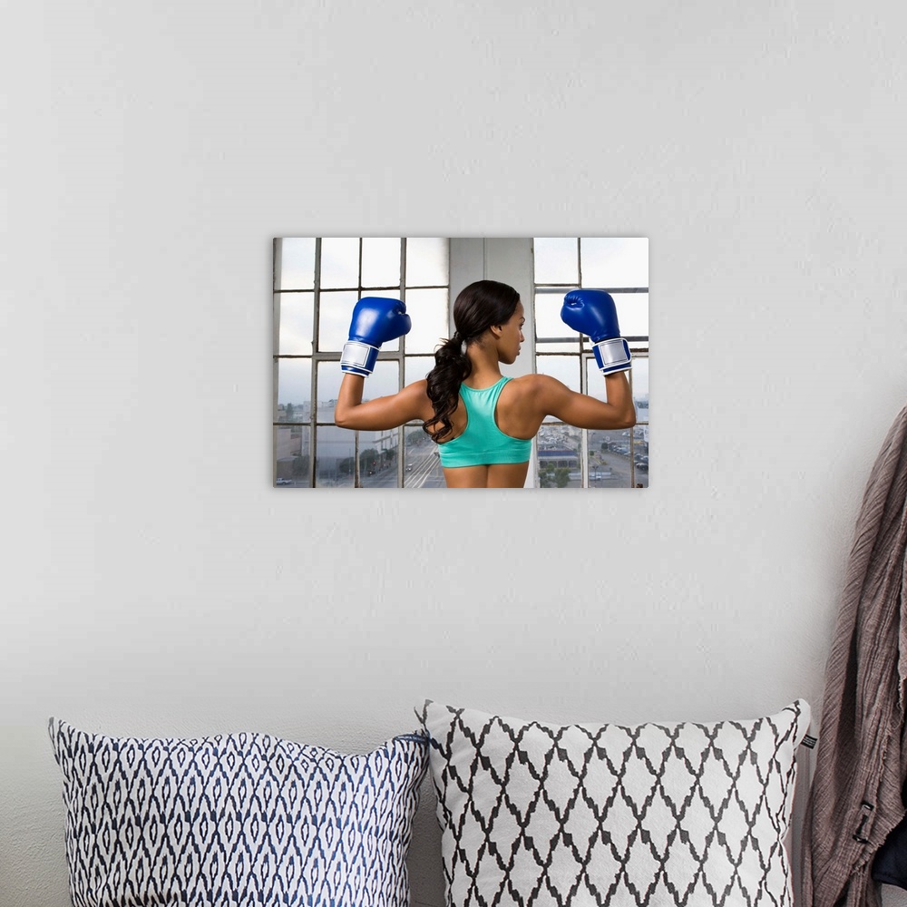 A bohemian room featuring Back view of boxer flexing muscles