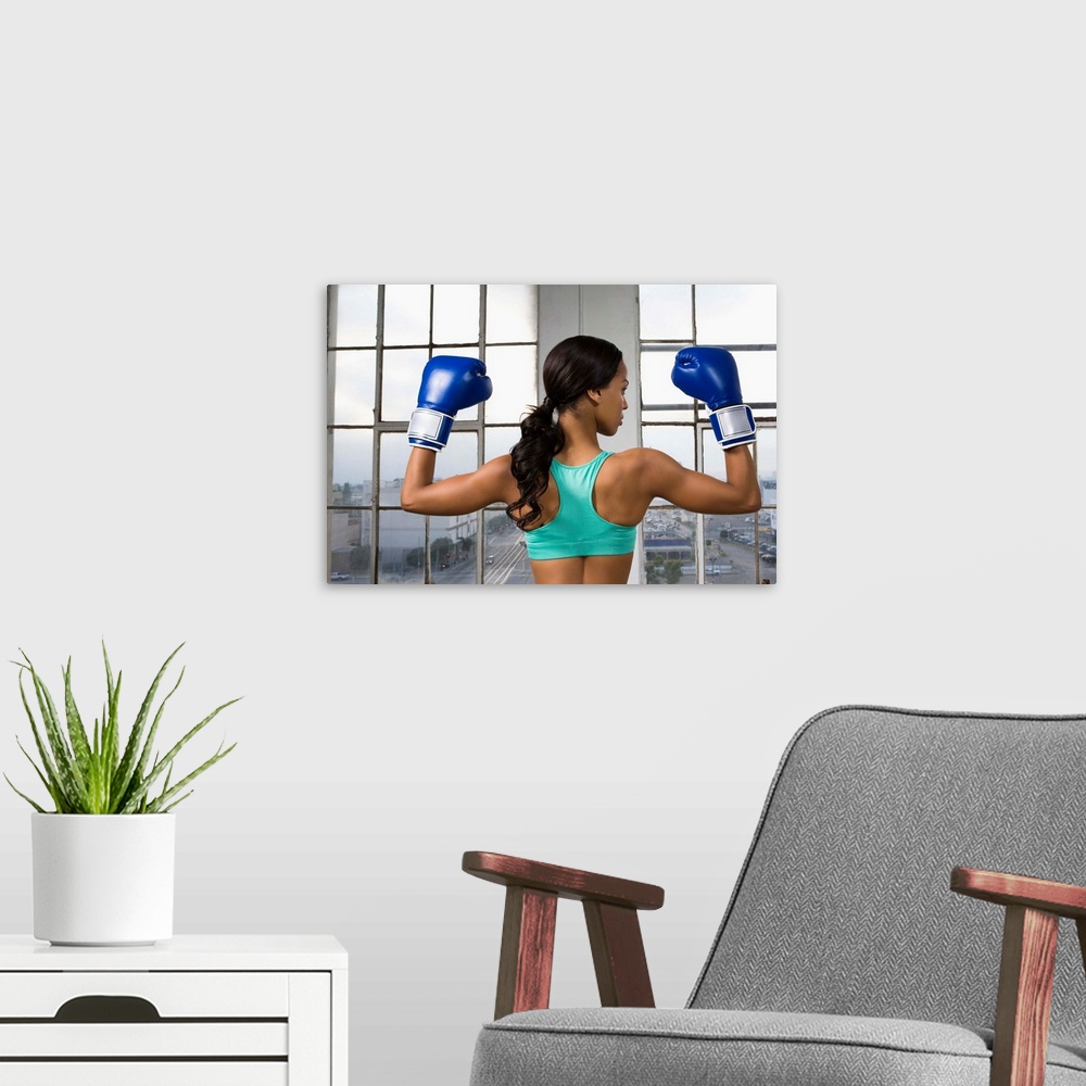 A modern room featuring Back view of boxer flexing muscles
