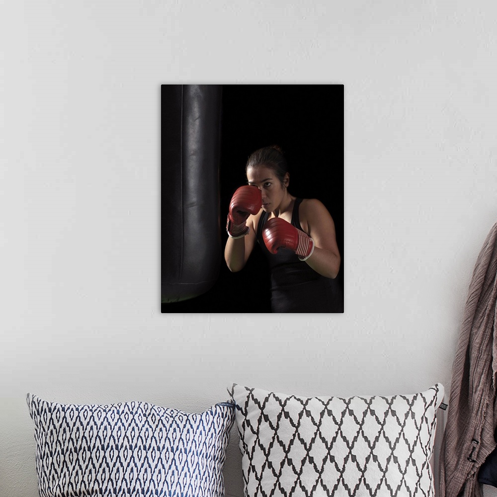 A bohemian room featuring Female boxer training on punching bag