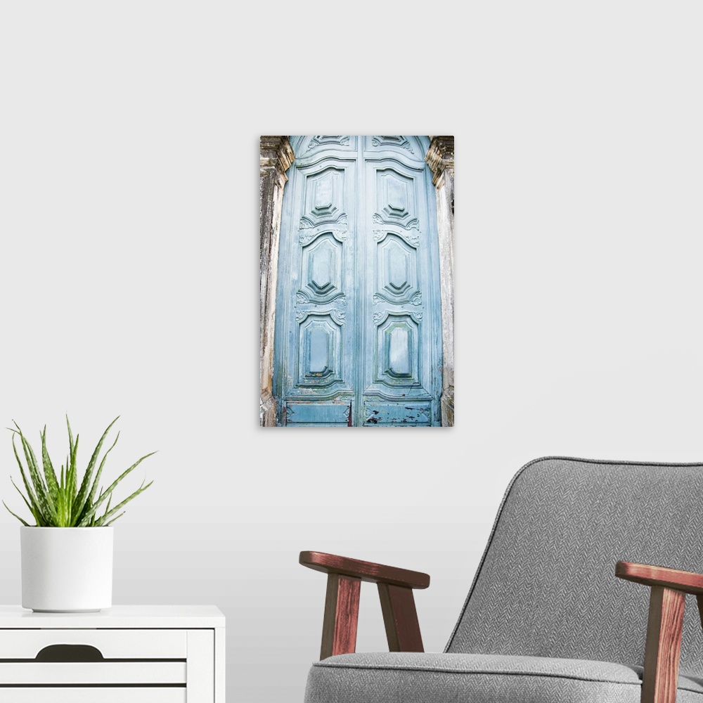 A modern room featuring Vertical photo print of a tall antique door.