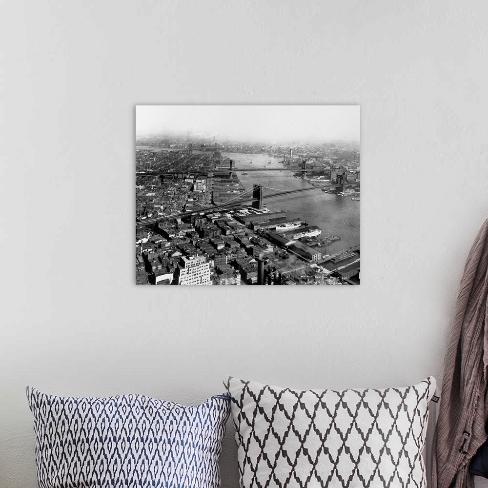 A bohemian room featuring A view up the East River with the Brooklyn, Manhattan and Williamsburg bridges as seen from Wall ...