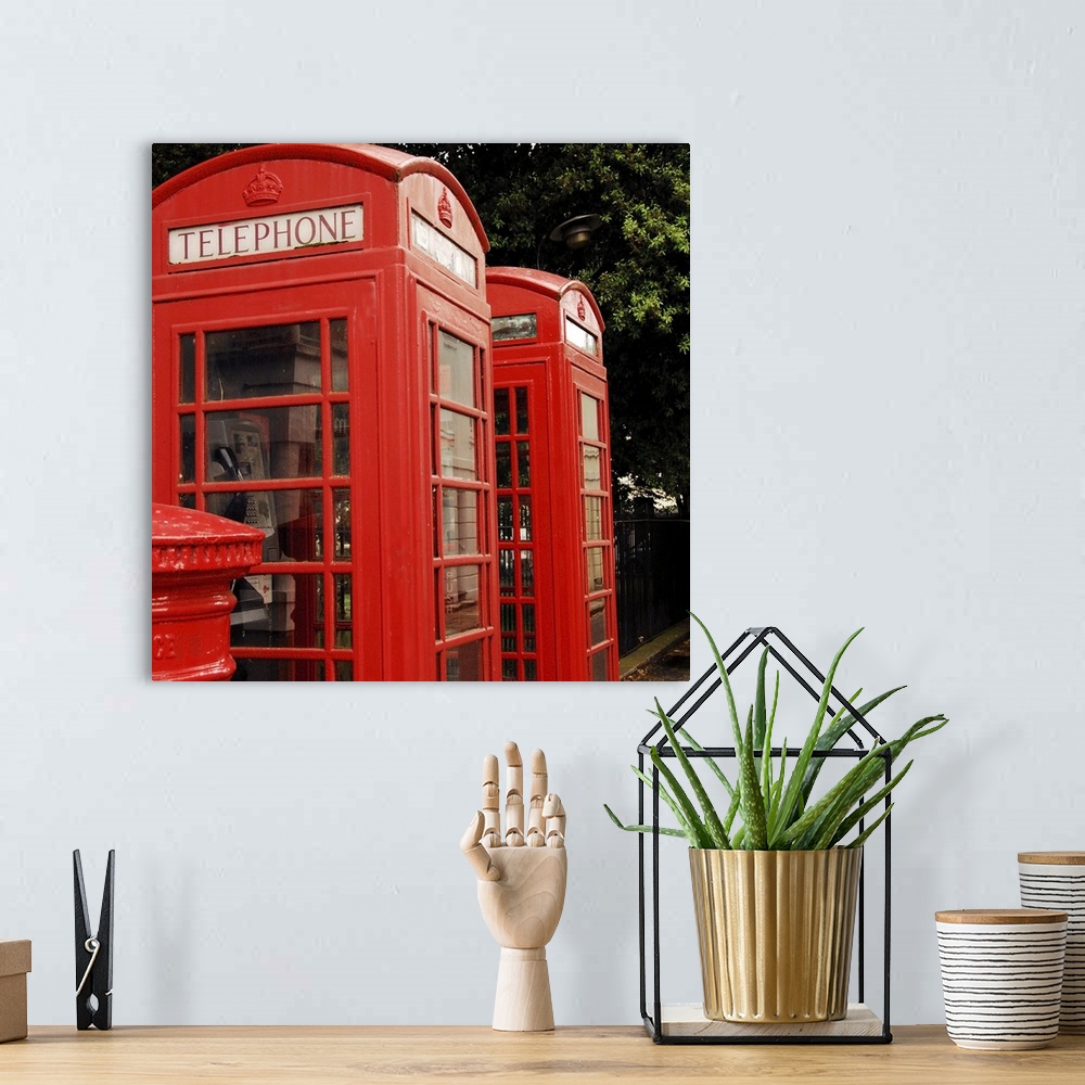 A bohemian room featuring British red telephone boxes and post box