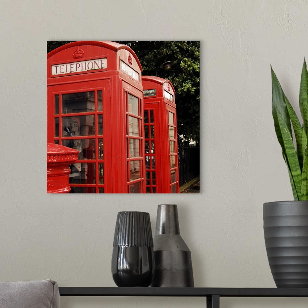 A modern room featuring British red telephone boxes and post box