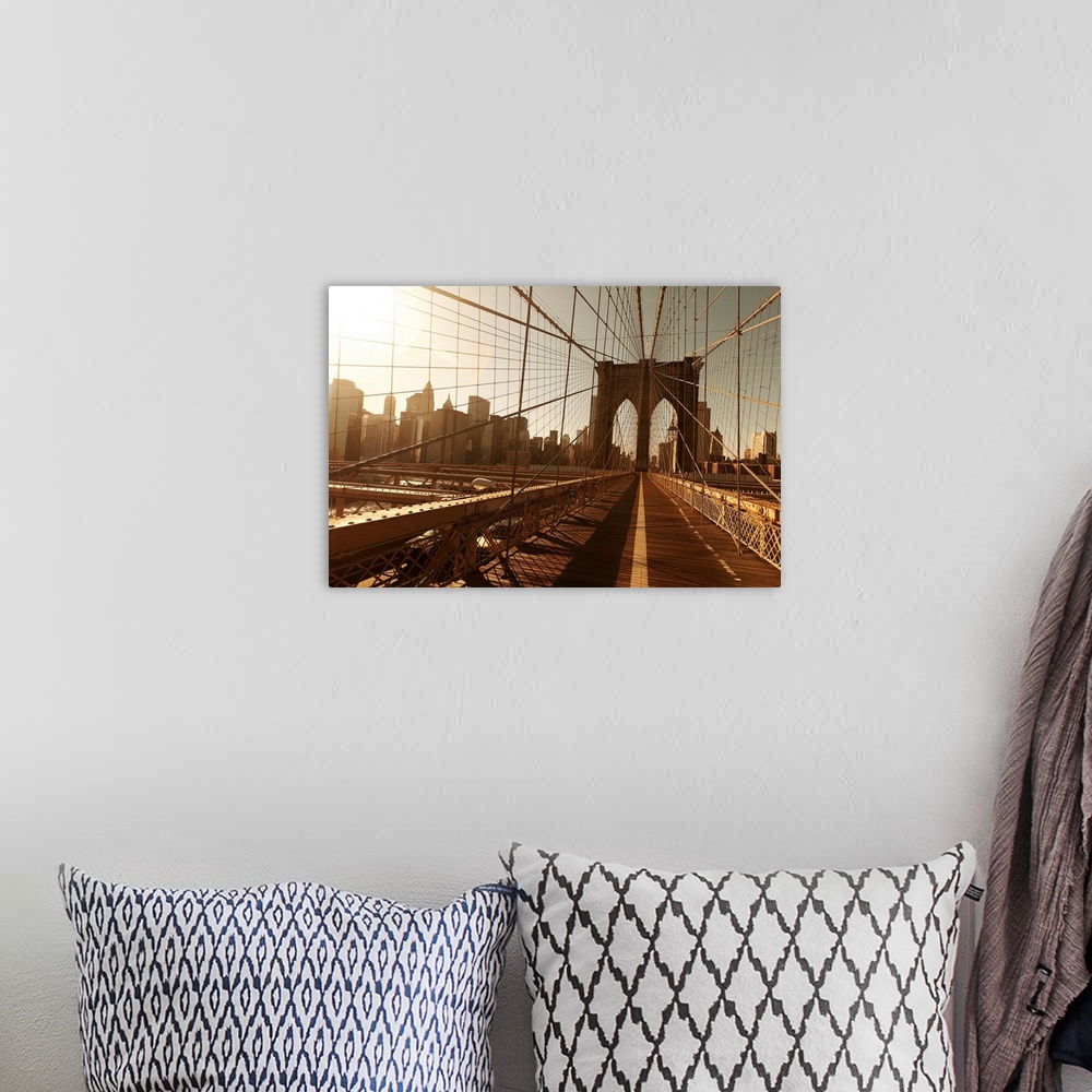 A bohemian room featuring Landscape, oversized photograph of the Brooklyn Bridge, taken through a multitude of cables, with...