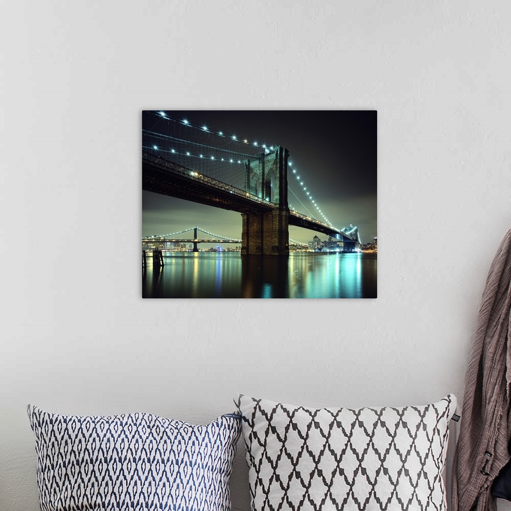 A bohemian room featuring Horizontal photograph on a large wall hanging of the Brooklyn Bridge at night, the  Manhattan Bri...