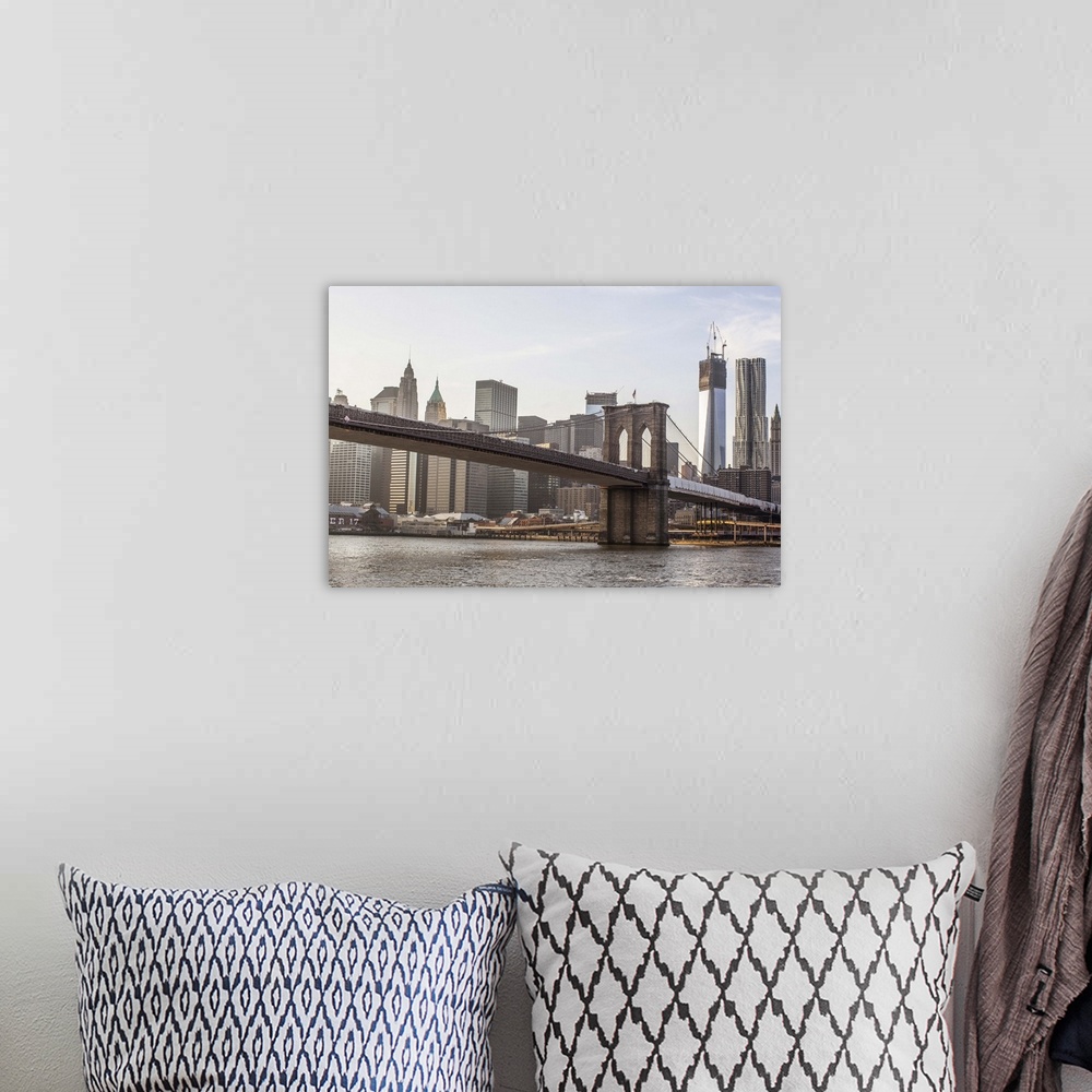 A bohemian room featuring A shot of Brooklyn Bridge with the New York City skyline in the background, including the One Wor...