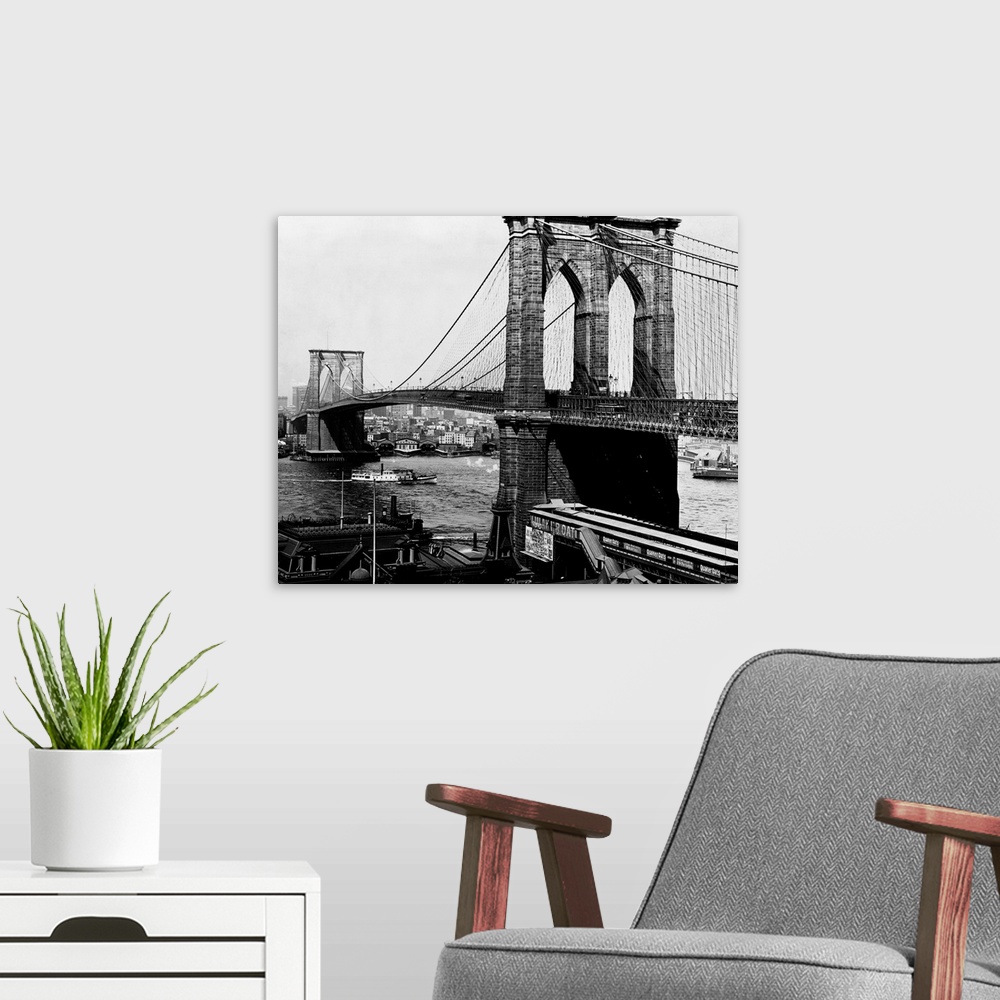 A modern room featuring A view of the Brooklyn Bridge, an engineering feat. When the bridge was completed in 1883, it was...