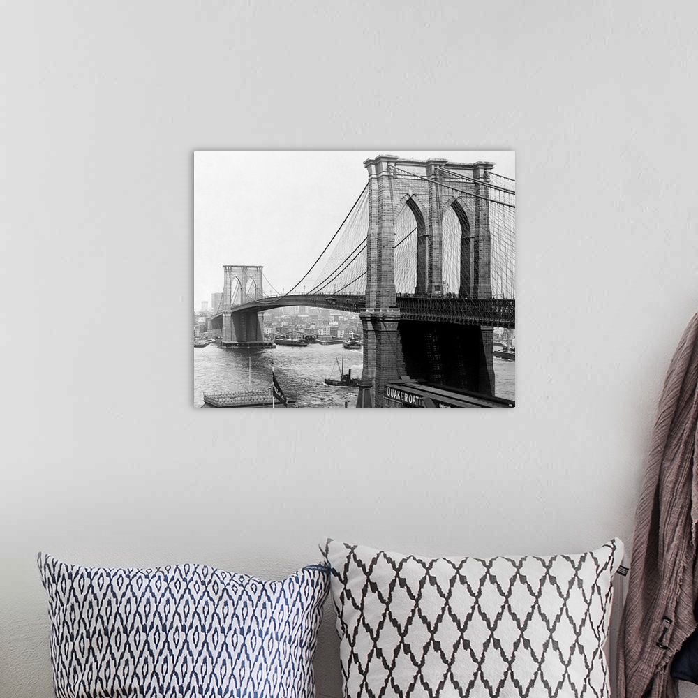 A bohemian room featuring A view of the Brooklyn Bridge which spans across the East River connecting Manhattan Island to Br...