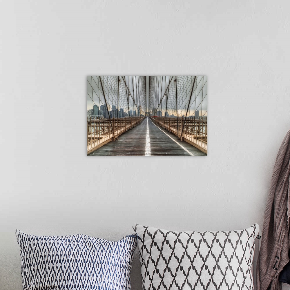 A bohemian room featuring Cables of the Brooklyn Bridge surrounding the walkway.