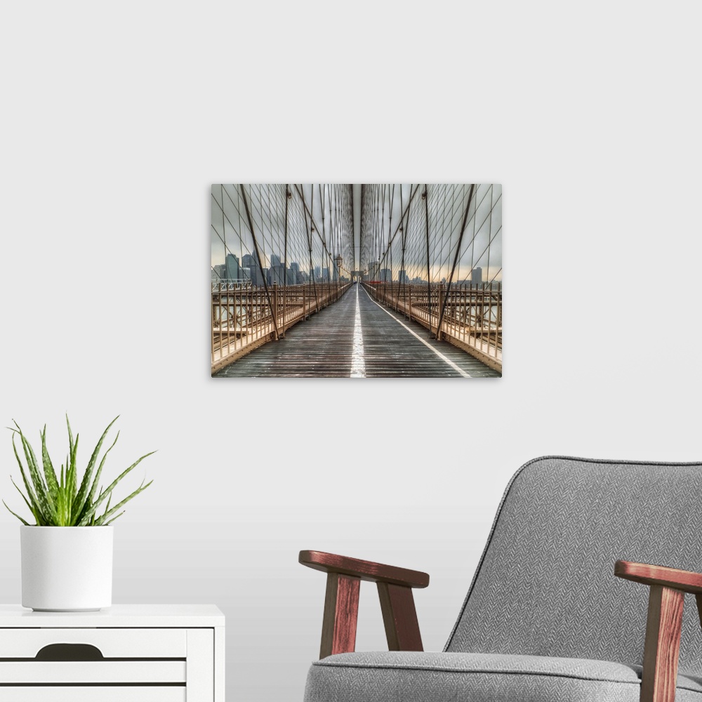 A modern room featuring Cables of the Brooklyn Bridge surrounding the walkway.