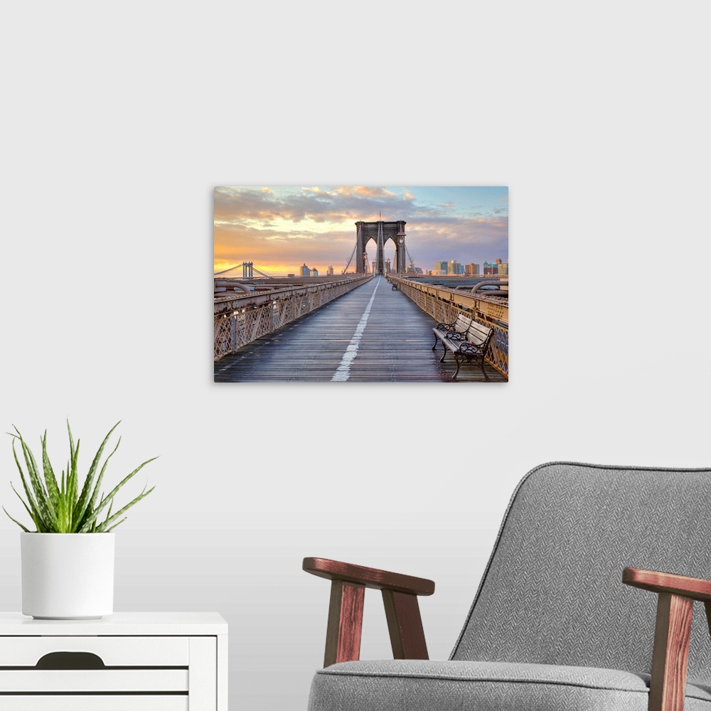 A modern room featuring Dusk picture taken on the Brooklyn Bridge looking down the pedestrian walkway towards Brooklyn.