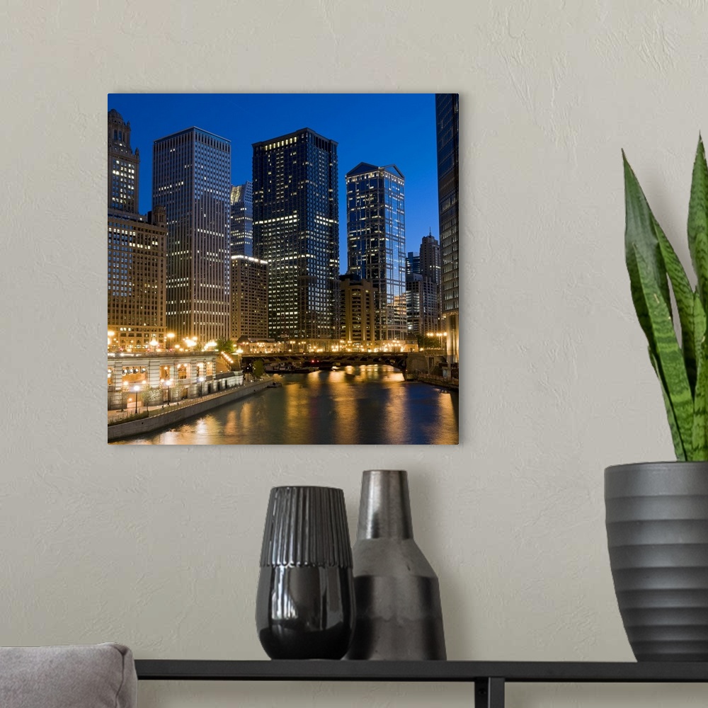 A modern room featuring Wall docor of Chicago buildings lit up with a bridge running across the river.
