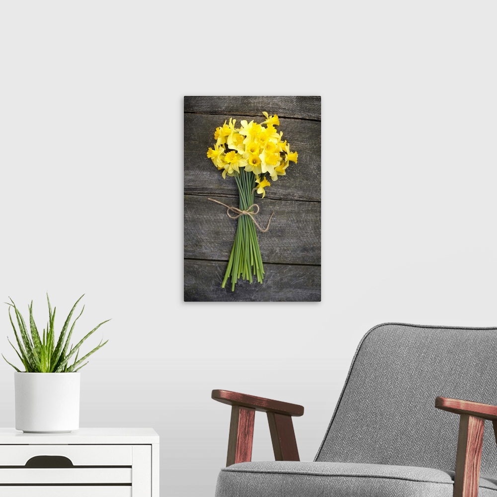 A modern room featuring Bunch of daffodils on a wooden table