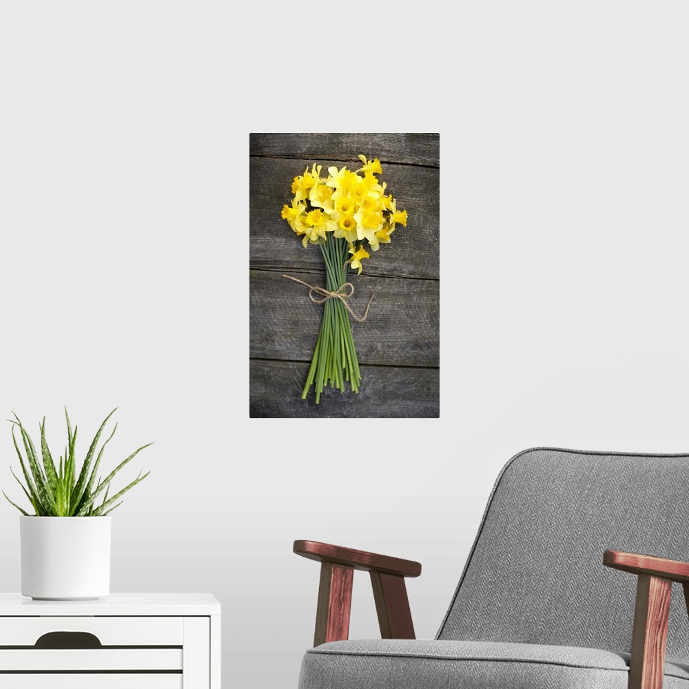 A modern room featuring Bunch of daffodils on a wooden table