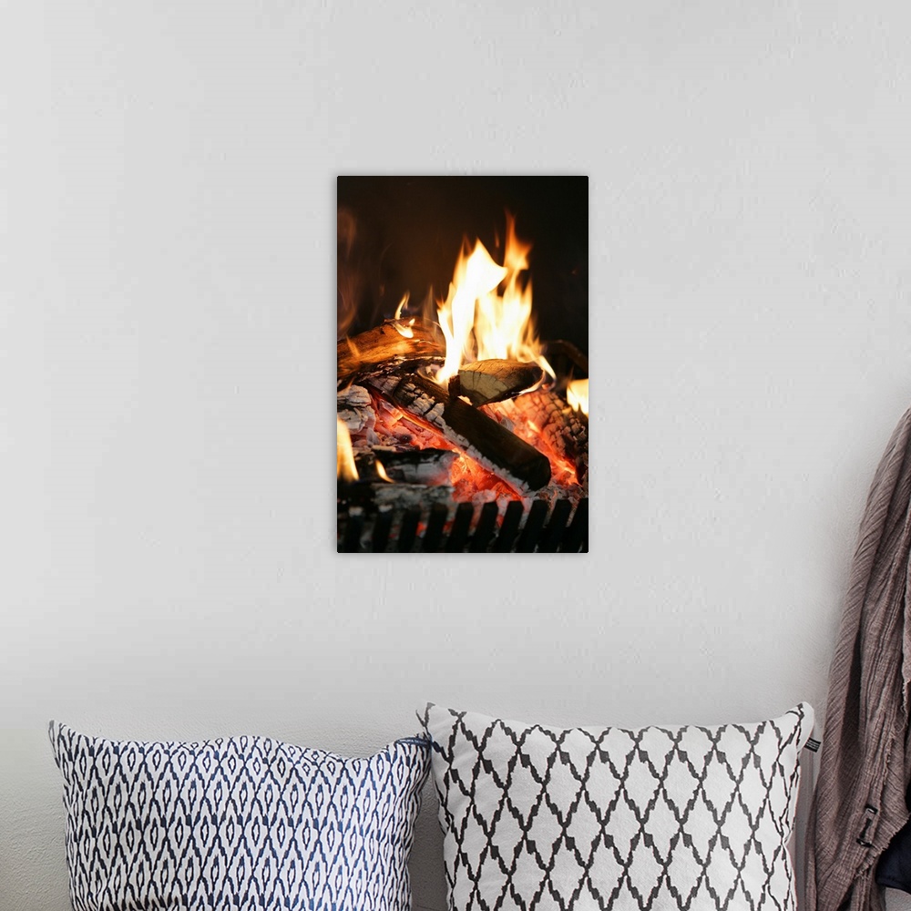 A bohemian room featuring Burning logs in fireplace