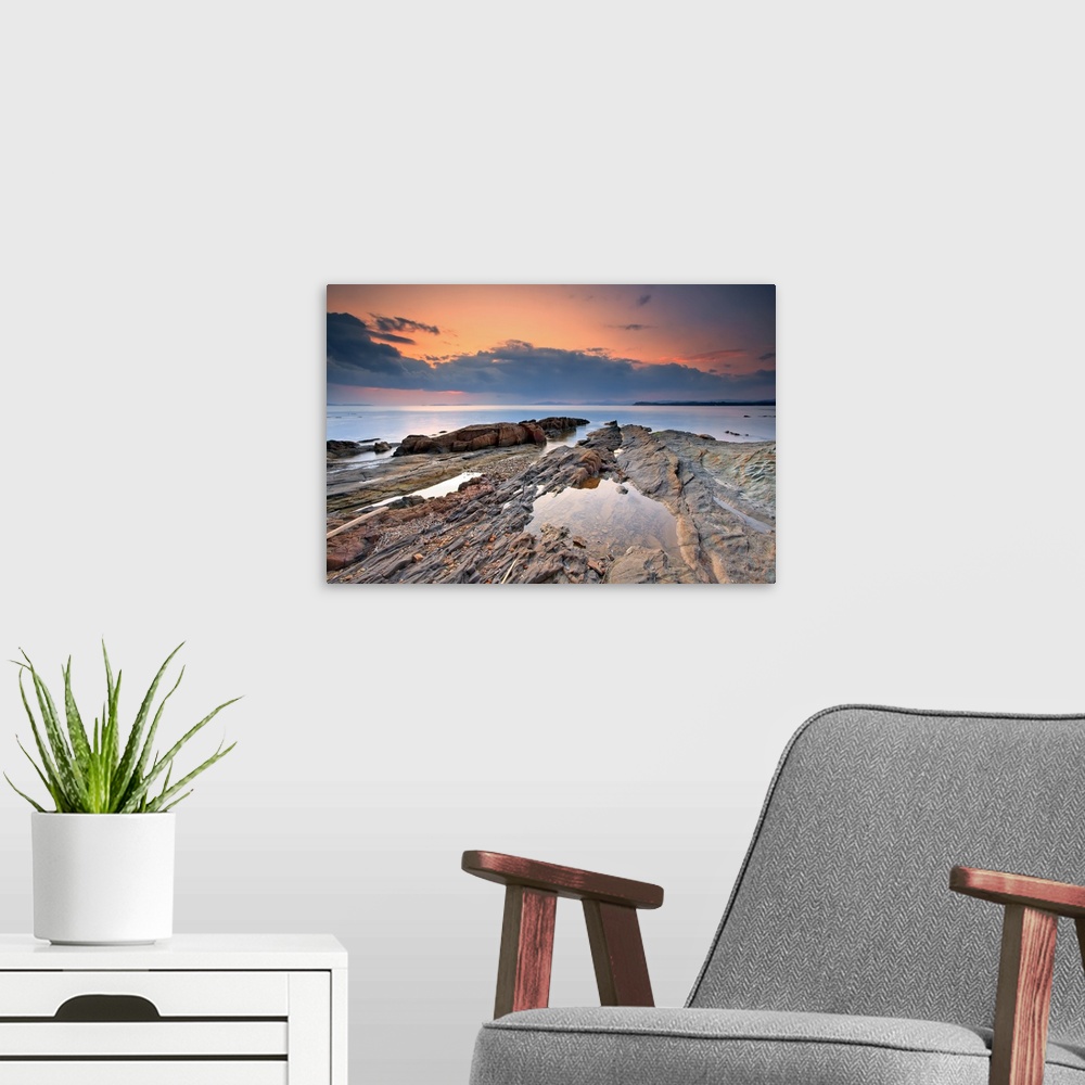 A modern room featuring Cabasson Beach at sunset