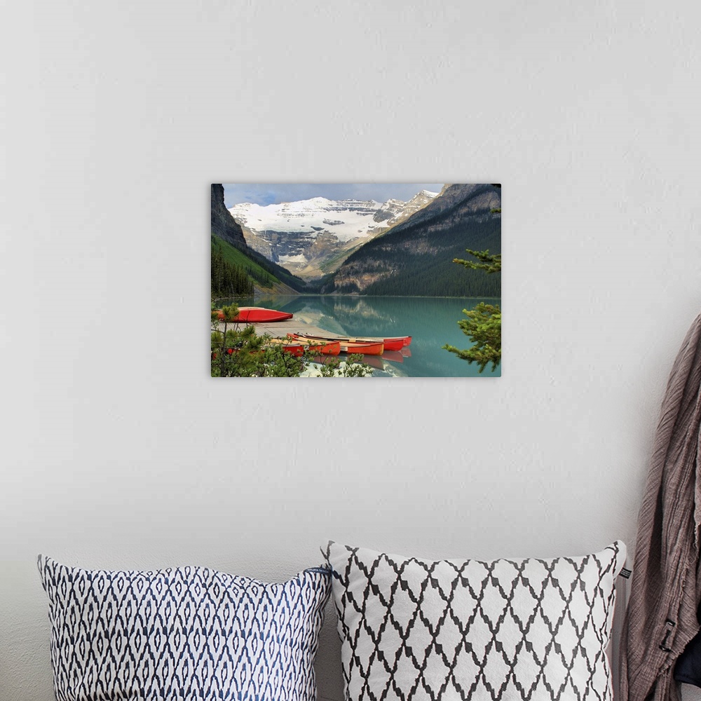 A bohemian room featuring red canoes on Lake Louise in Banff National Park