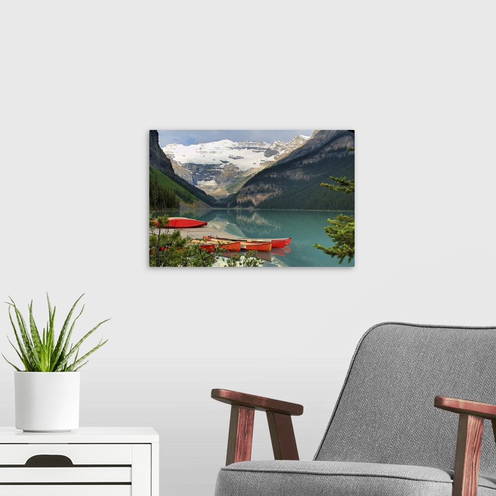 A modern room featuring red canoes on Lake Louise in Banff National Park