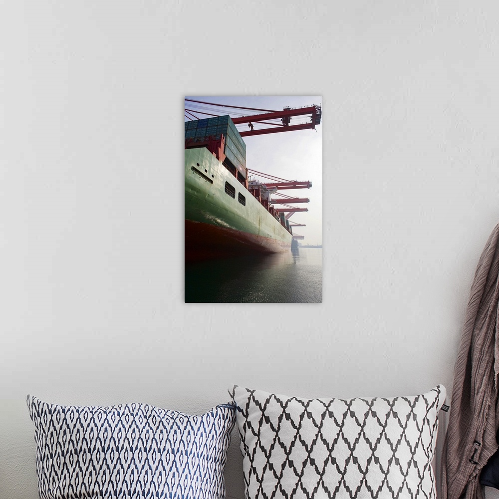 A bohemian room featuring Cargo ship at port being loaded.