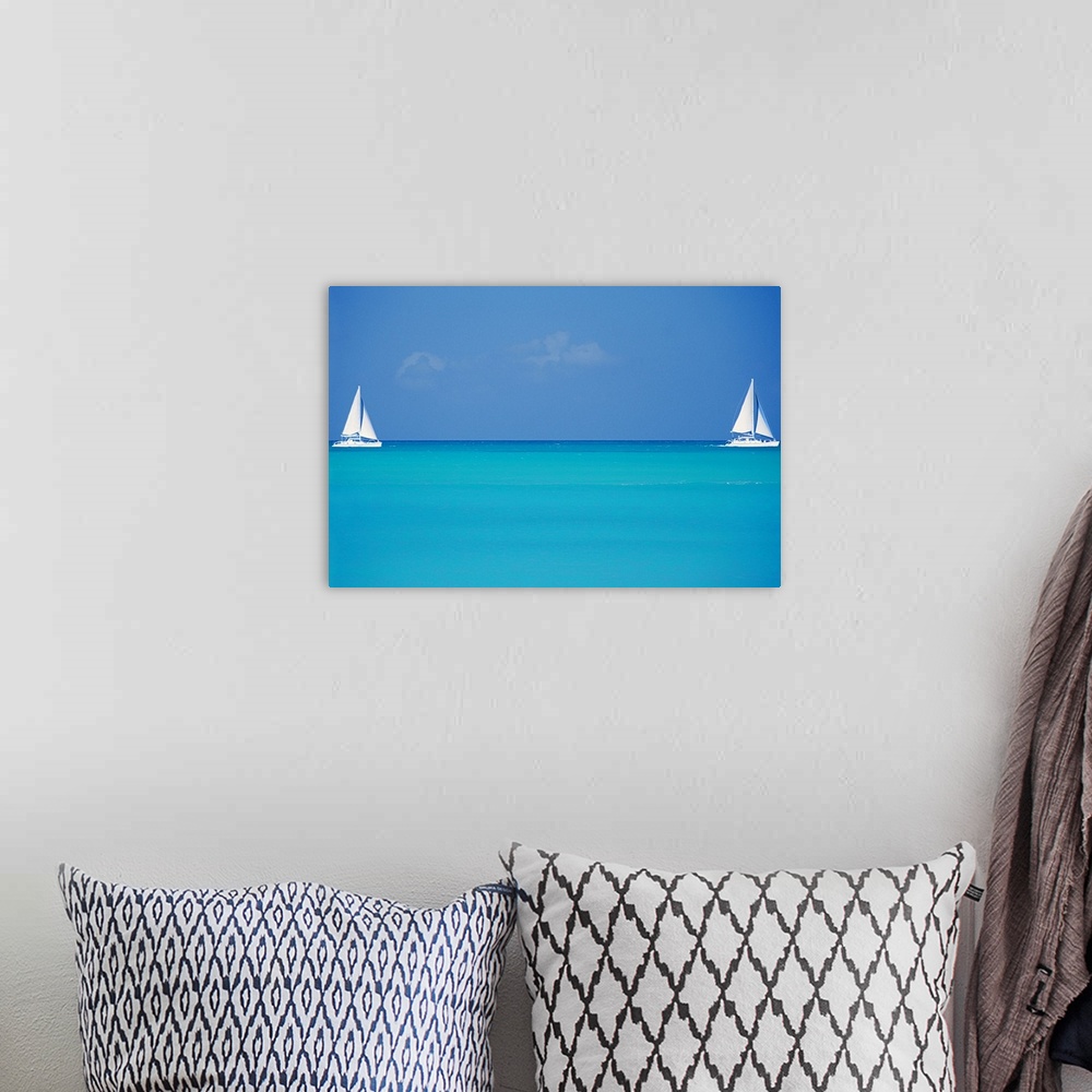 A bohemian room featuring Canvas print of two sailboats floating in clear ocean water with one on the left and one on the r...