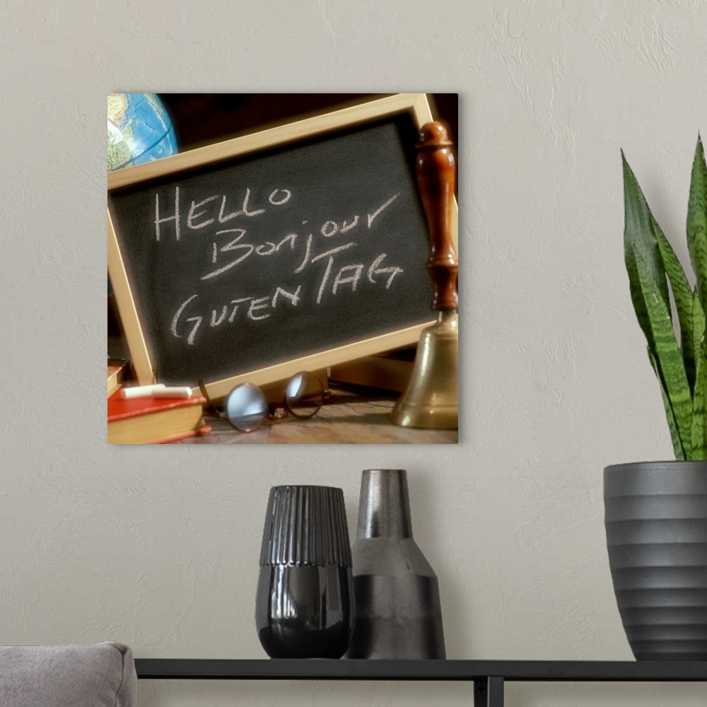 A modern room featuring Chalkboard with greetings written in English, French and German