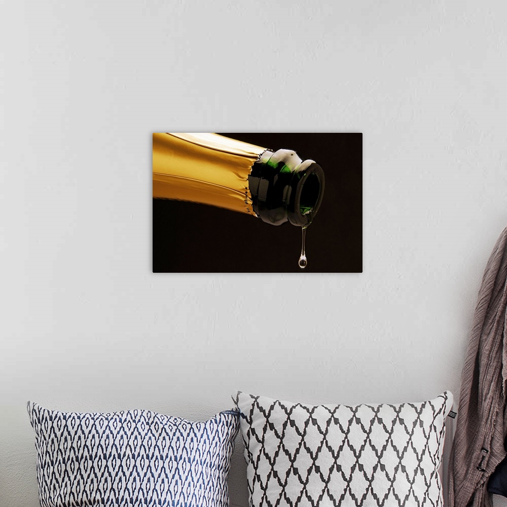 A bohemian room featuring Champagne drop dripping from bottle, close-up