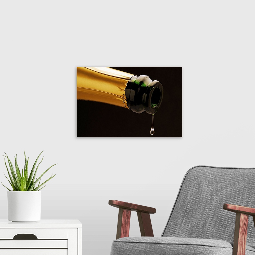 A modern room featuring Champagne drop dripping from bottle, close-up