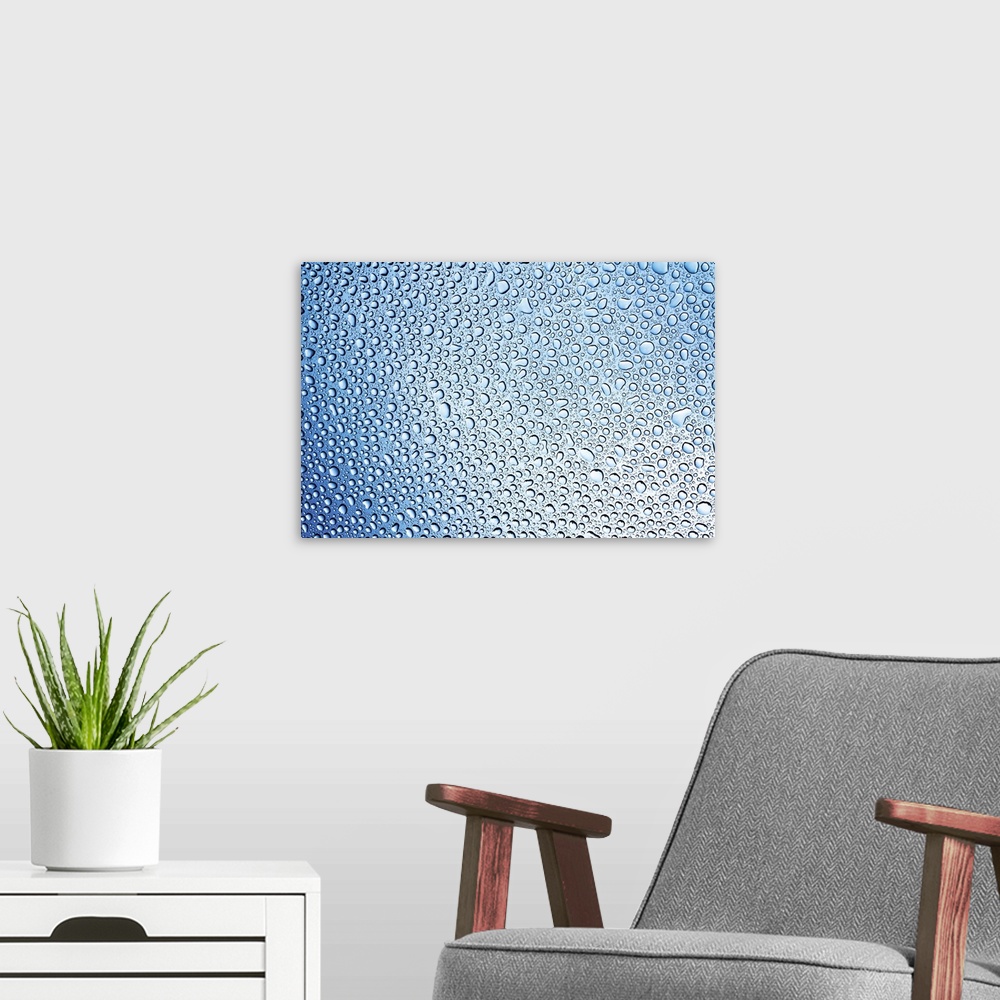 A modern room featuring changing lightness of water drops on glass after rain