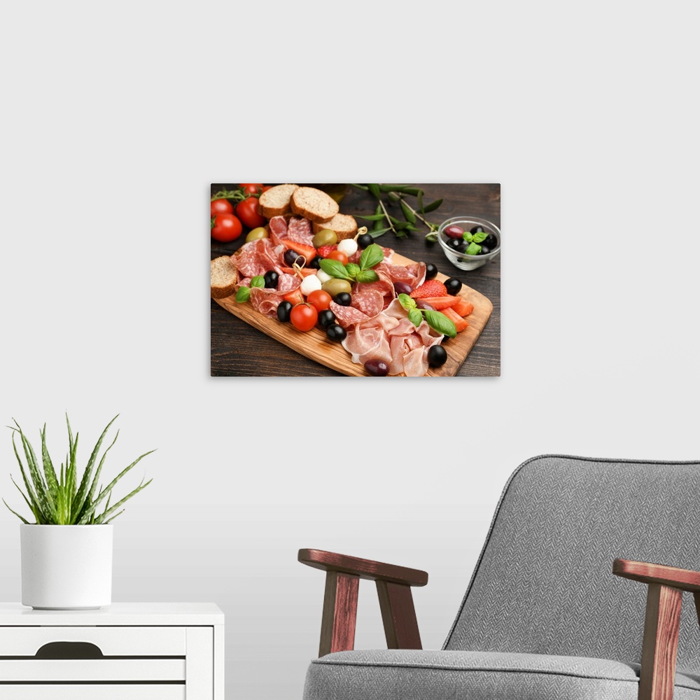 A modern room featuring Charcuterie board salami, prosciutto, with green and black olives, appetizers with mozzarella bal...
